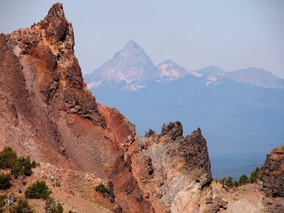 [Several heights of jagged, lumpy rocks in foreground with haze over mountains in distance.]